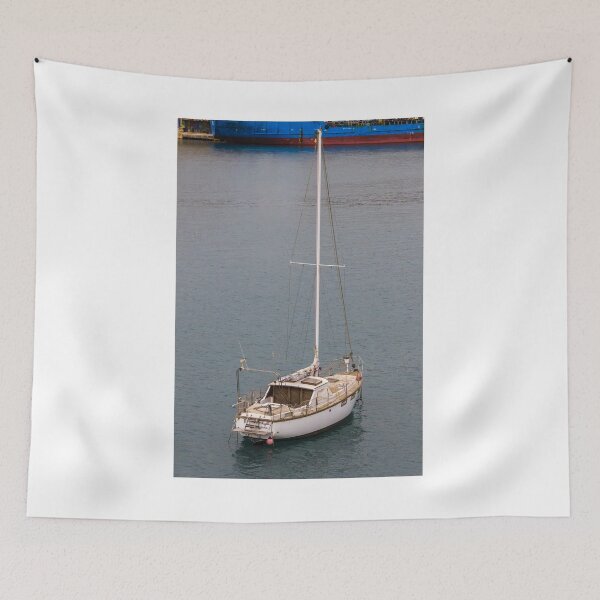 Item preview, Relaxing Sailboat Floating in Calm Harbor With Large Blue Vessel in Background Near Industrial Dock Scenery designed and sold by Nmallia.