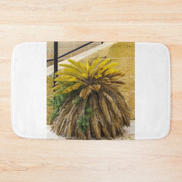 Item preview, Yellow Palm Fronds Grow From A Foliage Bush Beside A Stony Staircase Wall designed and sold by Nmallia.