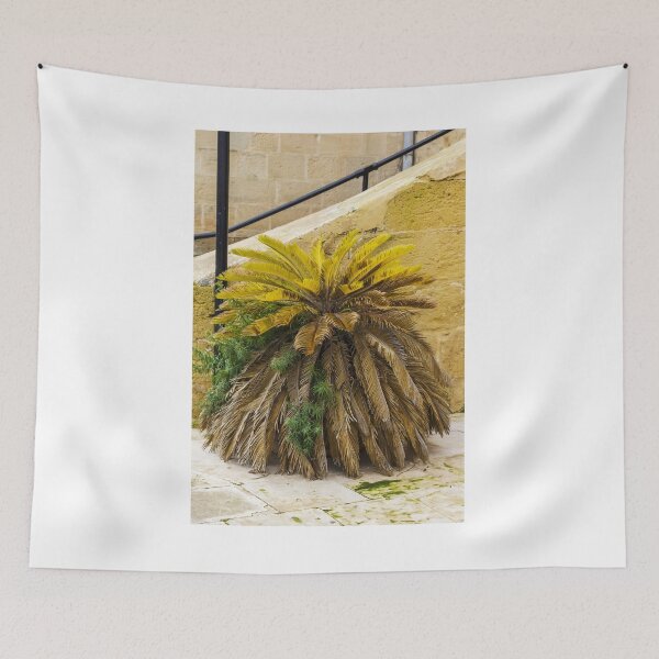 Item preview, Yellow Palm Fronds Grow From A Foliage Bush Beside A Stony Staircase Wall designed and sold by Nmallia.