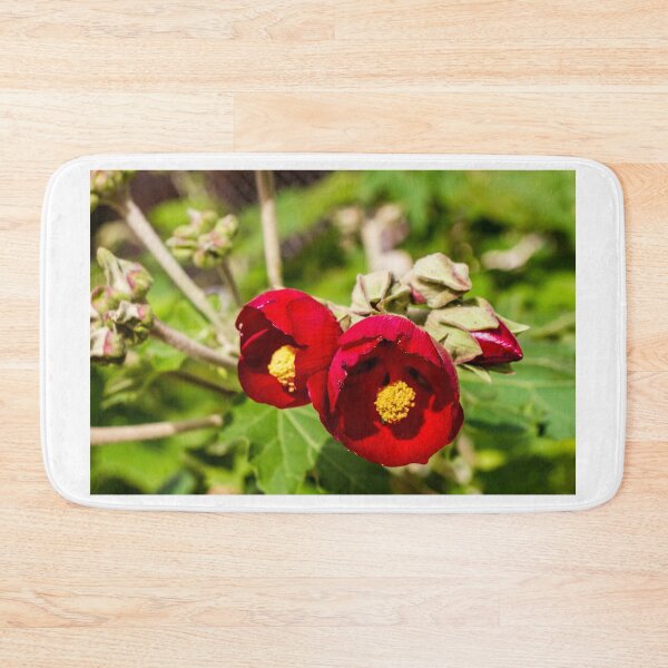 Item preview, Bright Red Hibiscus Flowers With Yellow Centers In Green Garden Setting designed and sold by Nmallia.