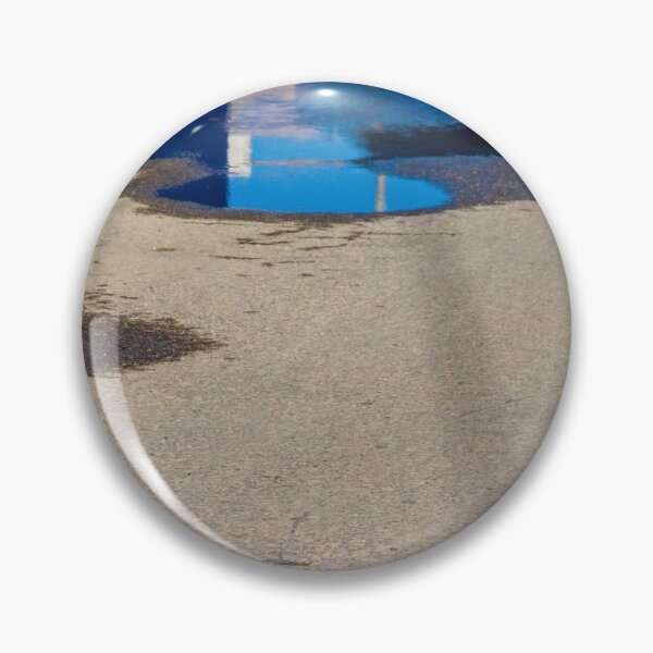 Item preview, Puddle On Wet Road Surface Reflects Buildings In Bright Urban Street Scene designed and sold by Nmallia.