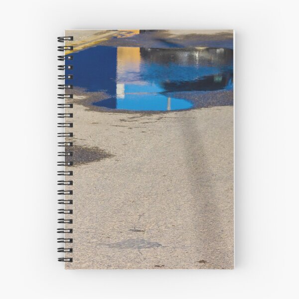 Item preview, Puddle On Wet Road Surface Reflects Buildings In Bright Urban Street Scene designed and sold by Nmallia.