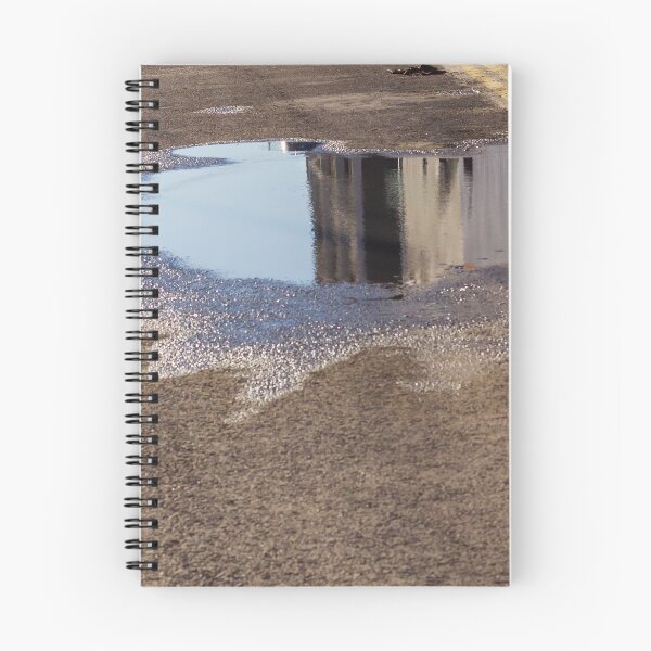Item preview, Puddle On Wet Road Surface Reflects Buildings In Bright Urban Street Scene designed and sold by Nmallia.