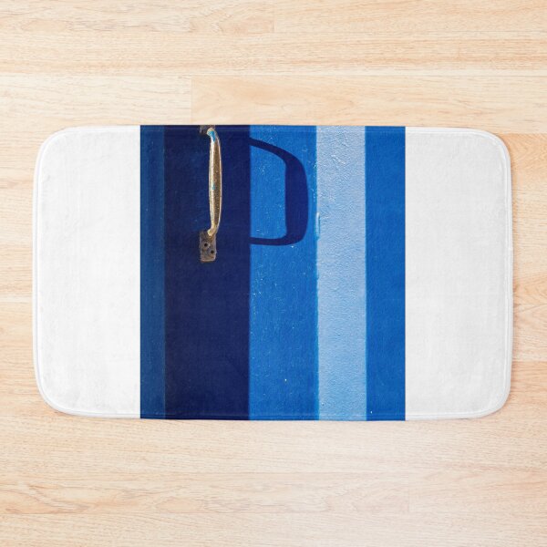 Item preview, Vibrant Blue Door With Rustic Metal Handle And Dramatic Shadow On Bright Wall designed and sold by Nmallia.