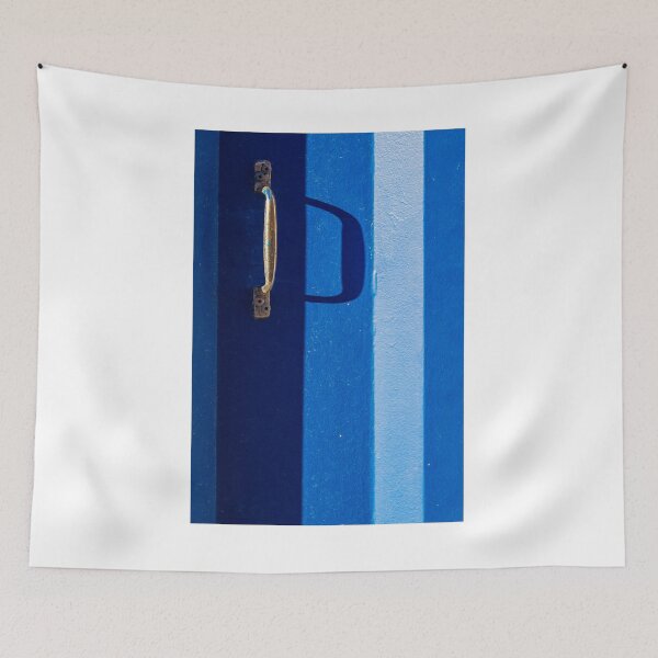 Item preview, Vibrant Blue Door With Rustic Metal Handle And Dramatic Shadow On Bright Wall designed and sold by Nmallia.