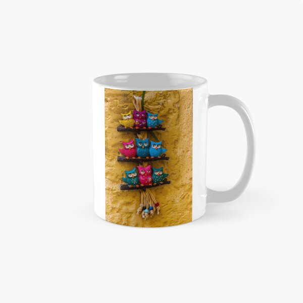 Item preview, Colorful Decorative Owl Figurines Hanging outside on a Yellow Textured Wall designed and sold by Nmallia.