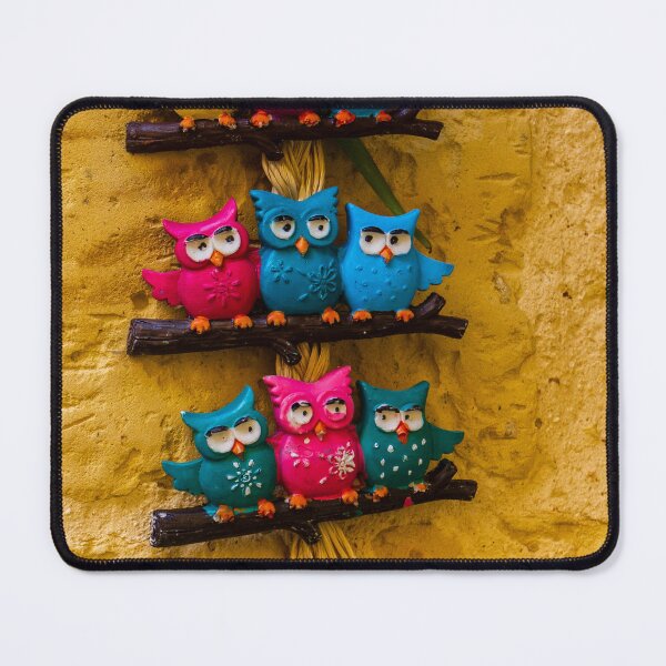 Item preview, Colorful Decorative Owl Figurines Hanging outside on a Yellow Textured Wall designed and sold by Nmallia.
