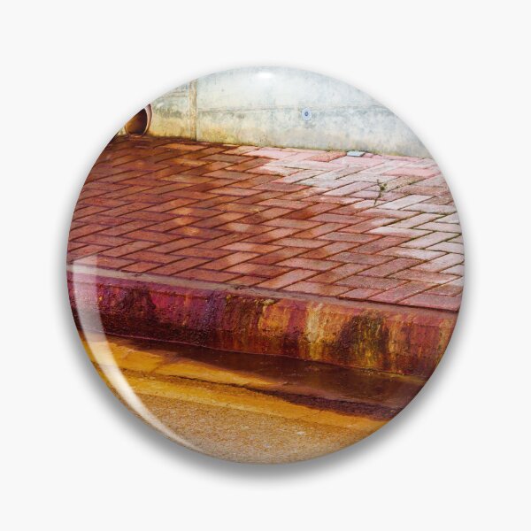 Item preview, Urban Street Curb With Bricked Sidewalk and Sewer Vent Pipes Against Weathered Concrete Wall designed and sold by Nmallia.
