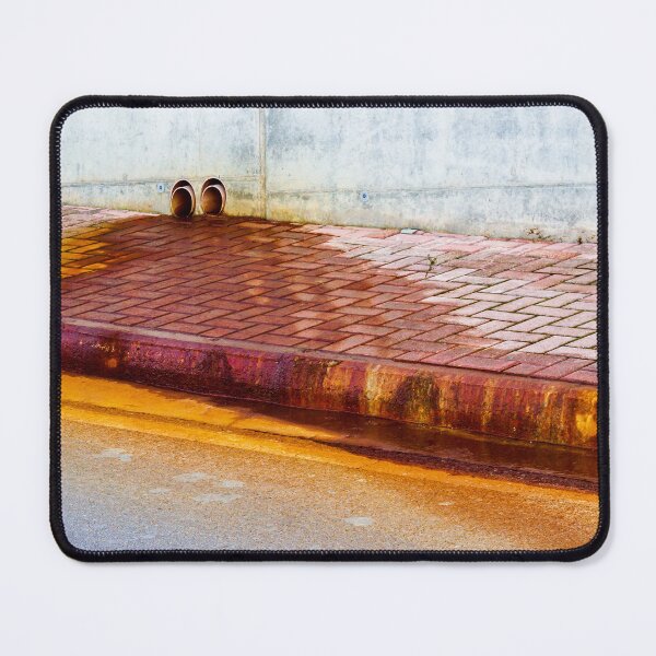 Item preview, Urban Street Curb With Bricked Sidewalk and Sewer Vent Pipes Against Weathered Concrete Wall designed and sold by Nmallia.