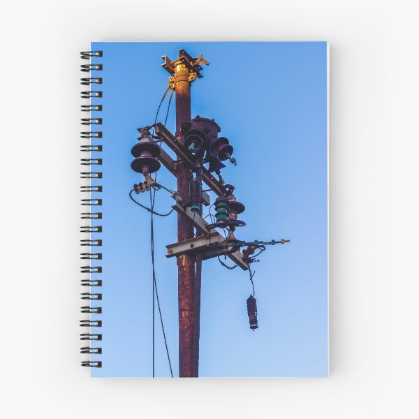 Item preview, Rusty Electrical Power Pole With Insulators Against Clear Blue Sky at Sunset designed and sold by Nmallia.
