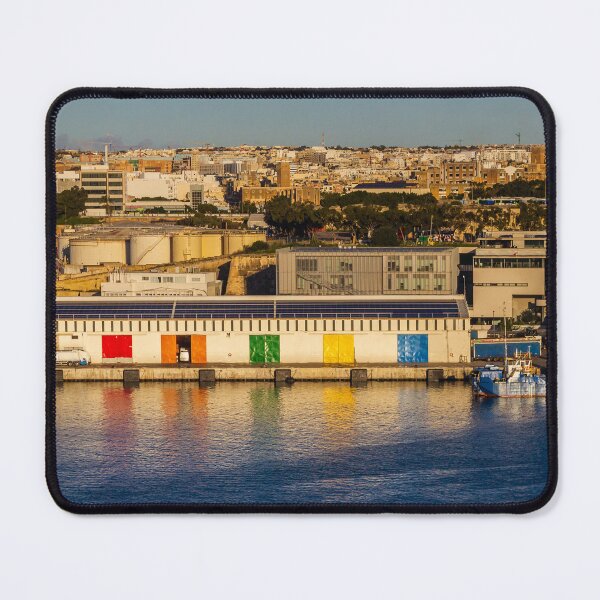 Item preview, Colorful Waterfront Warehouse Doors Along Harbor With City Skyline At Sunset designed and sold by Nmallia.