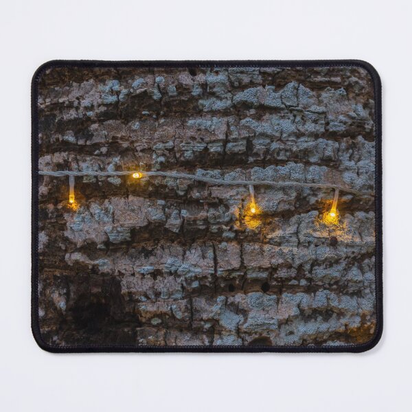 Item preview, Warm String Lights Cast Cozy Glow Across Rough Stone Wall For Rustic Festive Ambience designed and sold by Nmallia.