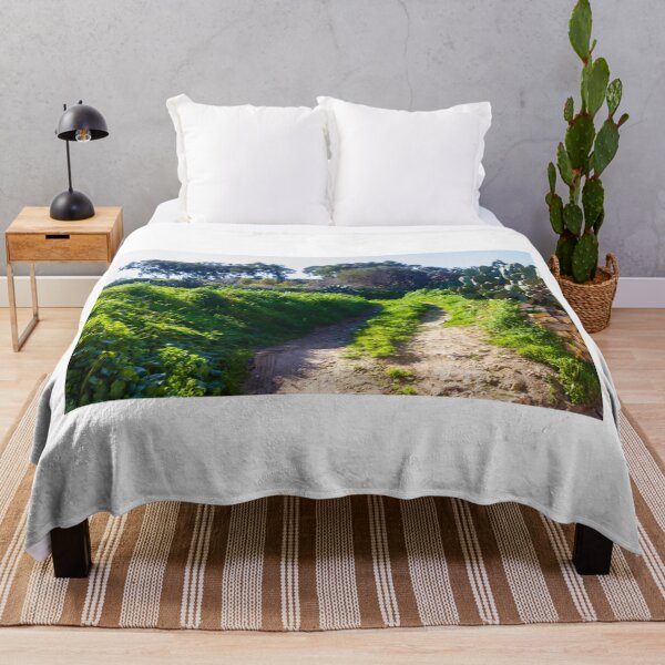 Item preview, Rural Dirt Path Through Lush Green Field With Cactus and Stone Wall Under Clear Sky designed and sold by Nmallia.