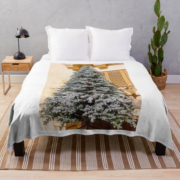 Item preview, Frosted Christmas Tree Outdoors Against a Classic Stone Building With Wooden Shutters designed and sold by Nmallia.