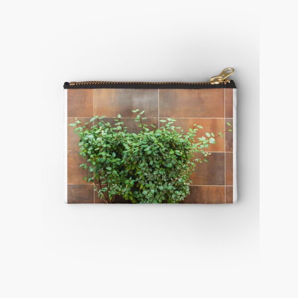 Item preview, Green Bush in Rusty Planter Against Brown Tile Wall for Urban Garden and Outdoor Decor designed and sold by Nmallia.