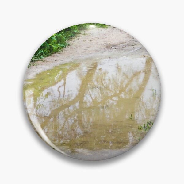 Item preview, Muddy Path With Puddle Reflection Along Lush Green Grass and Wildflowers designed and sold by Nmallia.