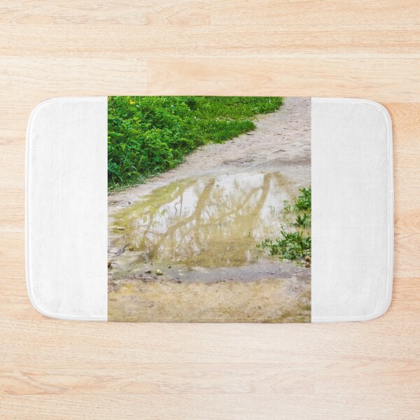 Item preview, Muddy Path With Puddle Reflection Along Lush Green Grass and Wildflowers designed and sold by Nmallia.