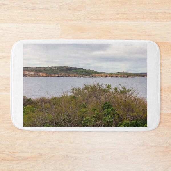 Item preview, Coastal Landscape With Calm Water, Distant Hills, And Lush Green Shoreline Bushes designed and sold by Nmallia.