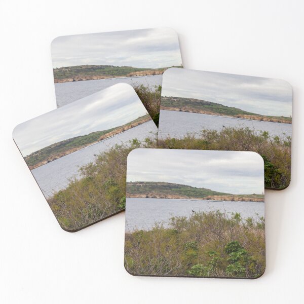 Item preview, Coastal Landscape With Calm Water, Distant Hills, And Lush Green Shoreline Bushes designed and sold by Nmallia.