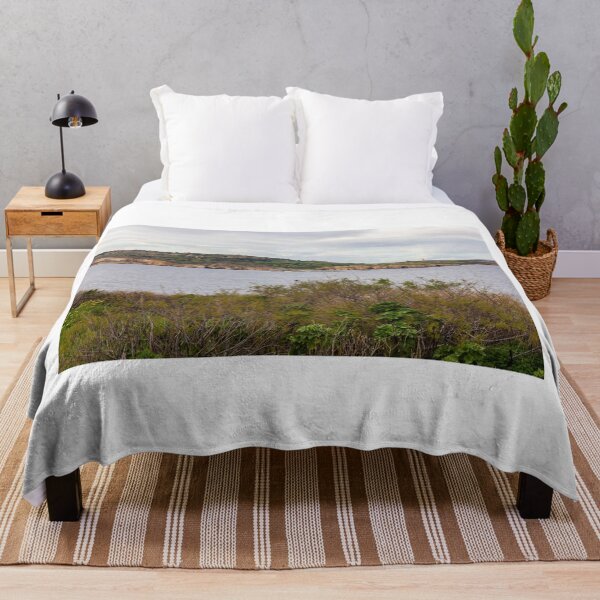 Item preview, Coastal Landscape With Calm Water, Distant Hills, And Lush Green Shoreline Bushes designed and sold by Nmallia.