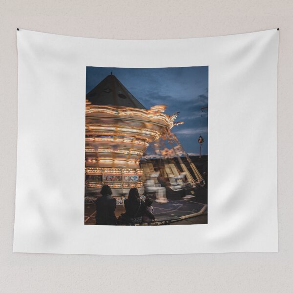 Item preview, Carousel with many lights turns fast in front of steady spectators designed and sold by brambillasimone.