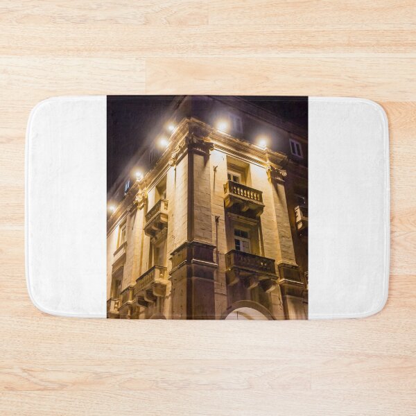 Item preview, Illuminated Historic Building Facade With Balconies And Ornate Architecture At Night On Street designed and sold by Nmallia.
