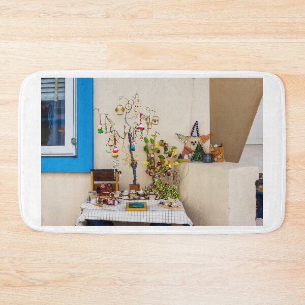 Item preview, Colorful Handmade Ornaments and Trinkets Displayed on Table Outside a Sunny Building designed and sold by Nmallia.