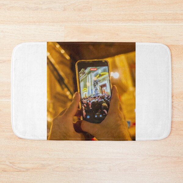 Item preview, Person Capturing Large Night Crowd At Decorative City Event On Smartphone With Festive Lighting And Architecture designed and sold by Nmallia.