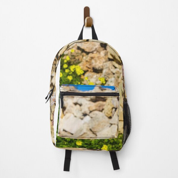 Item preview, Wildflower Blooming Against A Rustic Stone Wall With Yellow Clover And Blue Sky designed and sold by Nmallia.
