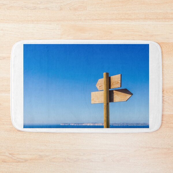 Item preview, Wooden Signpost With Arrow Signs Pointing Directions Against Blue Sky And Sea Horizon designed and sold by Nmallia.