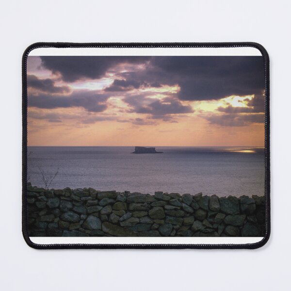 Item preview, Sunset Over Sea With Distant Islet and Foreground Stone Wall Under Dramatic Cloudy Sky designed and sold by Nmallia.