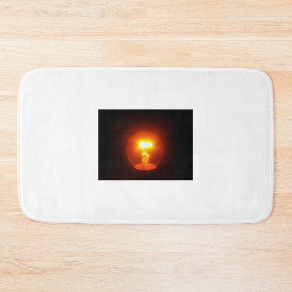 Item preview, Glowing Incandescent Light Bulb With Visible Filament Illuminating Warm Orange Light In Dark designed and sold by Nmallia.