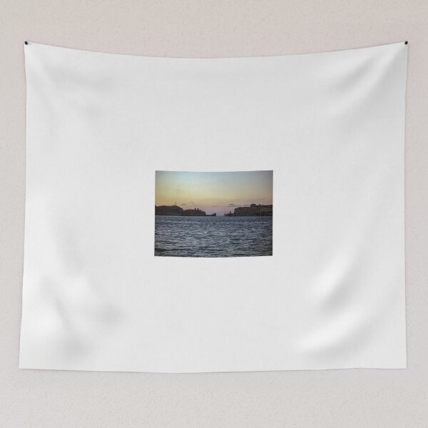Item preview, Sunlit Stone Seawall With People Fishing Along Coastal Promenade At Golden Hour designed and sold by Nmallia.
