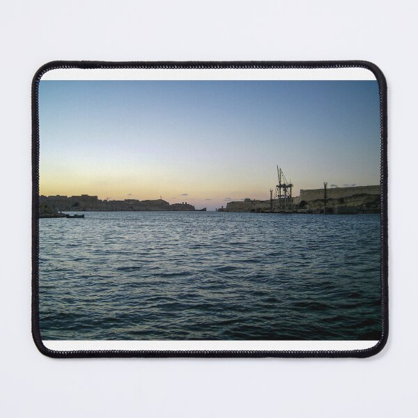 Item preview, Sunlit Stone Seawall With People Fishing Along Coastal Promenade At Golden Hour designed and sold by Nmallia.