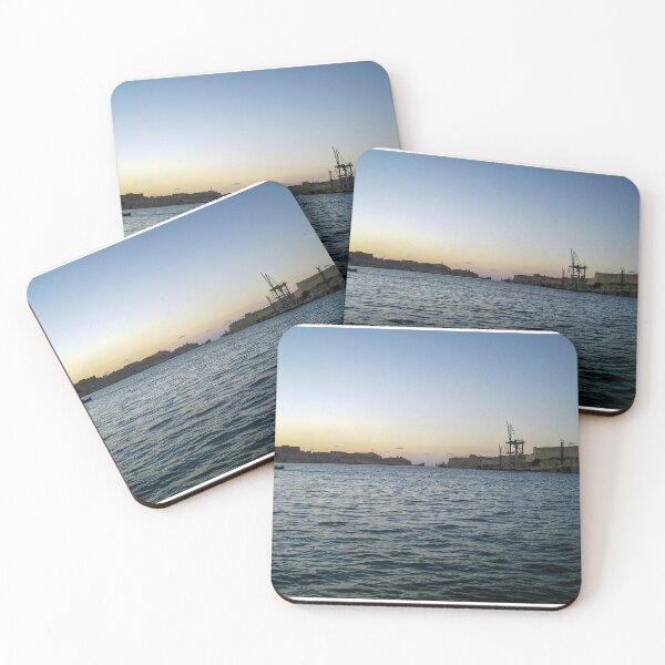 Item preview, Sunlit Stone Seawall With People Fishing Along Coastal Promenade At Golden Hour designed and sold by Nmallia.