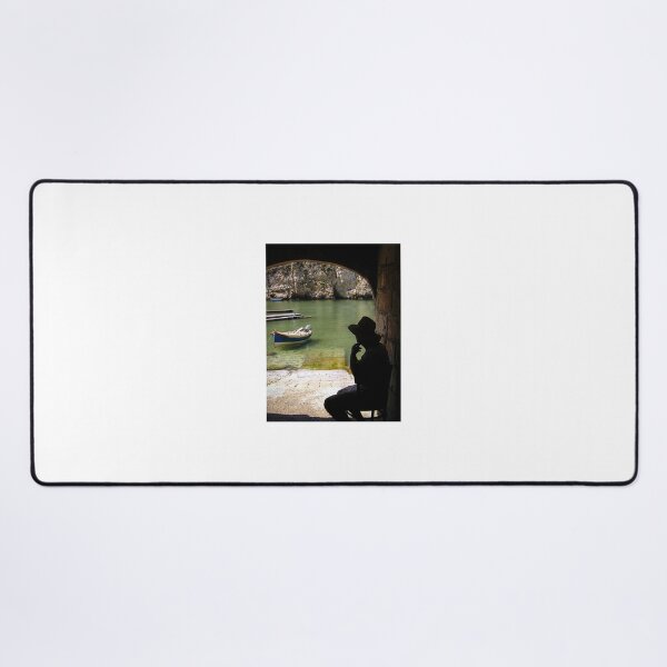 Item preview, Silhouette Of A Man In Hat Watching A Small Boat In A Quiet Coastal Harbor Under An Arch designed and sold by Nmallia.