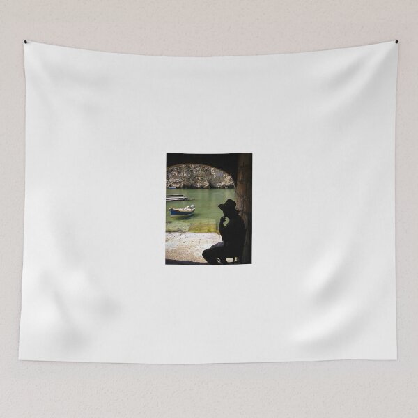 Item preview, Silhouette Of A Man In Hat Watching A Small Boat In A Quiet Coastal Harbor Under An Arch designed and sold by Nmallia.