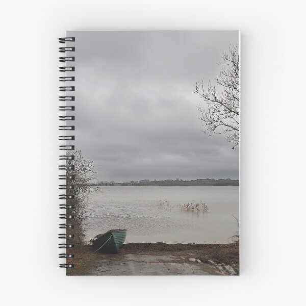 Item preview, Lonely Rowing boat On Shore Of Overcast Lough Under Gray Winter Sky designed and sold by ivon55.