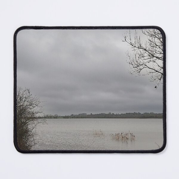 Item preview, Lonely Rowing boat On Shore Of Overcast Lough Under Gray Winter Sky designed and sold by ivon55.