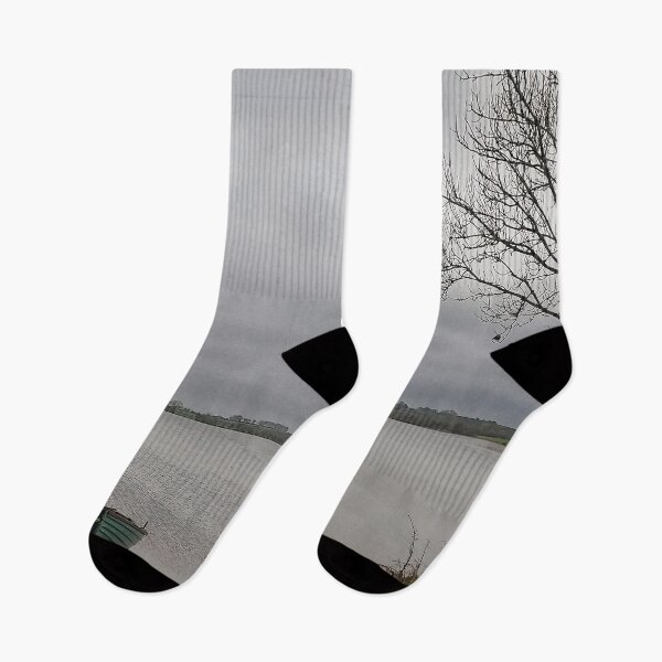 Item preview, Lonely Rowing boat On Shore Of Overcast Lough Under Gray Winter Sky designed and sold by ivon55.