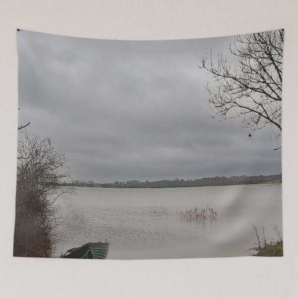 Item preview, Lonely Rowing boat On Shore Of Overcast Lough Under Gray Winter Sky designed and sold by ivon55.