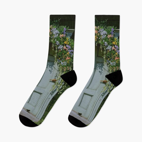Item preview, Green wooden door adorned with colorful flowers and greenery, leading to a charming entrance designed and sold by Stellar Geometry.