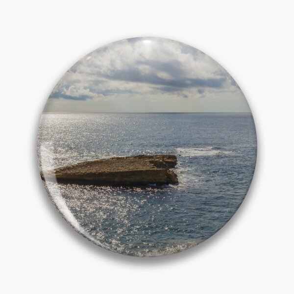 Item preview, Sunlit Rocky Coastline Overlooking Calm Ocean Waters Under Dramatic Cloudy Sky At Horizon designed and sold by Nmallia.
