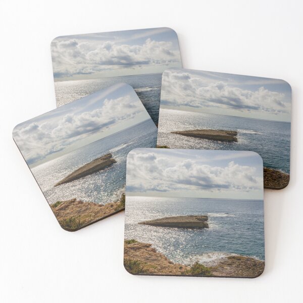 Item preview, Sunlit Rocky Coastline Overlooking Calm Ocean Waters Under Dramatic Cloudy Sky At Horizon designed and sold by Nmallia.