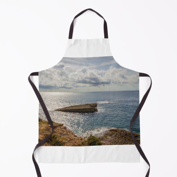 Item preview, Sunlit Rocky Coastline Overlooking Calm Ocean Waters Under Dramatic Cloudy Sky At Horizon designed and sold by Nmallia.