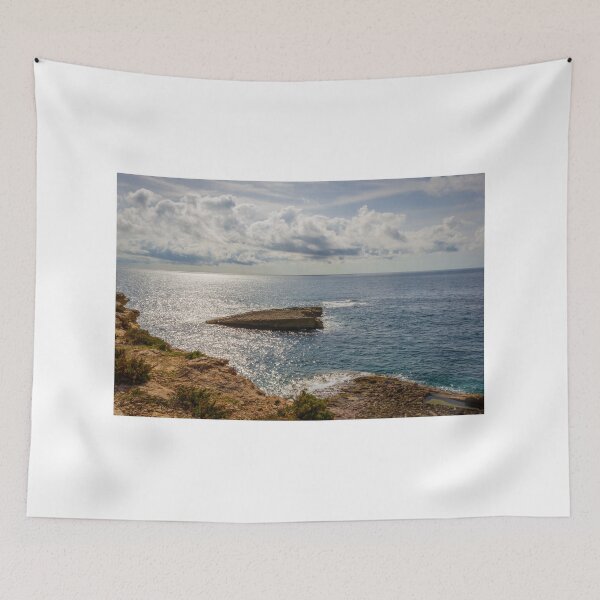 Item preview, Sunlit Rocky Coastline Overlooking Calm Ocean Waters Under Dramatic Cloudy Sky At Horizon designed and sold by Nmallia.