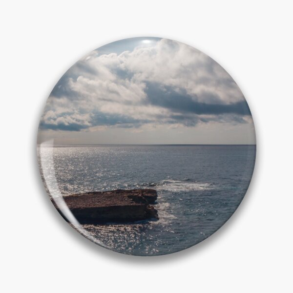 Item preview, Sunlit Rocky Coastline Overlooking Calm Ocean Waters Under Dramatic Cloudy Sky At Horizon designed and sold by Nmallia.