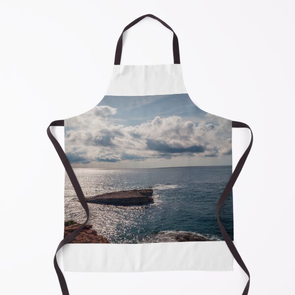 Item preview, Sunlit Rocky Coastline Overlooking Calm Ocean Waters Under Dramatic Cloudy Sky At Horizon designed and sold by Nmallia.