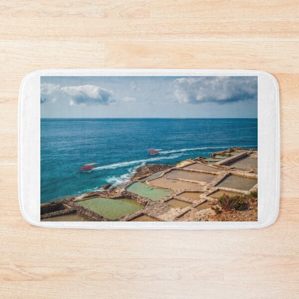 Item preview, Coastal Salt Pans Along Turquoise Sea With Boats and Rocky Cliffs Under Cloudy Sky designed and sold by Nmallia.