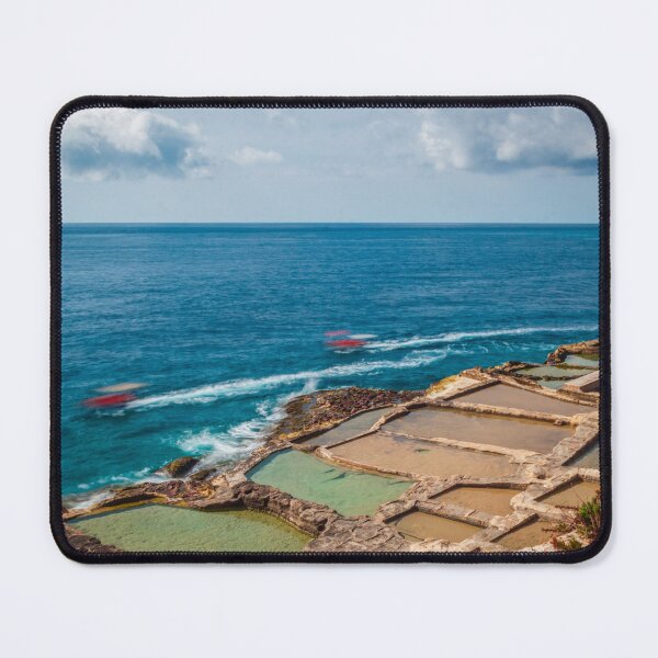 Item preview, Coastal Salt Pans Along Turquoise Sea With Boats and Rocky Cliffs Under Cloudy Sky designed and sold by Nmallia.